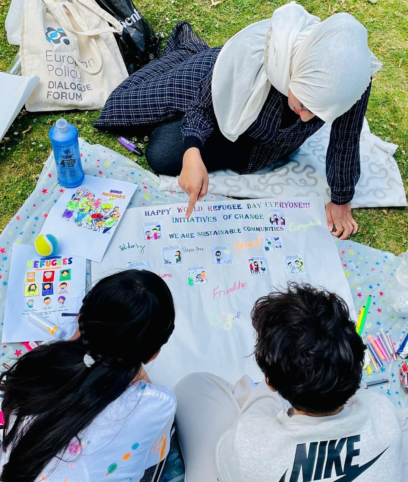 Photographed: IofC UK's Head of Sustainable Communities, Amina Khalid, helped the local children created colourful posters to understand and celebrate the meaning behind World Refugee Day. 