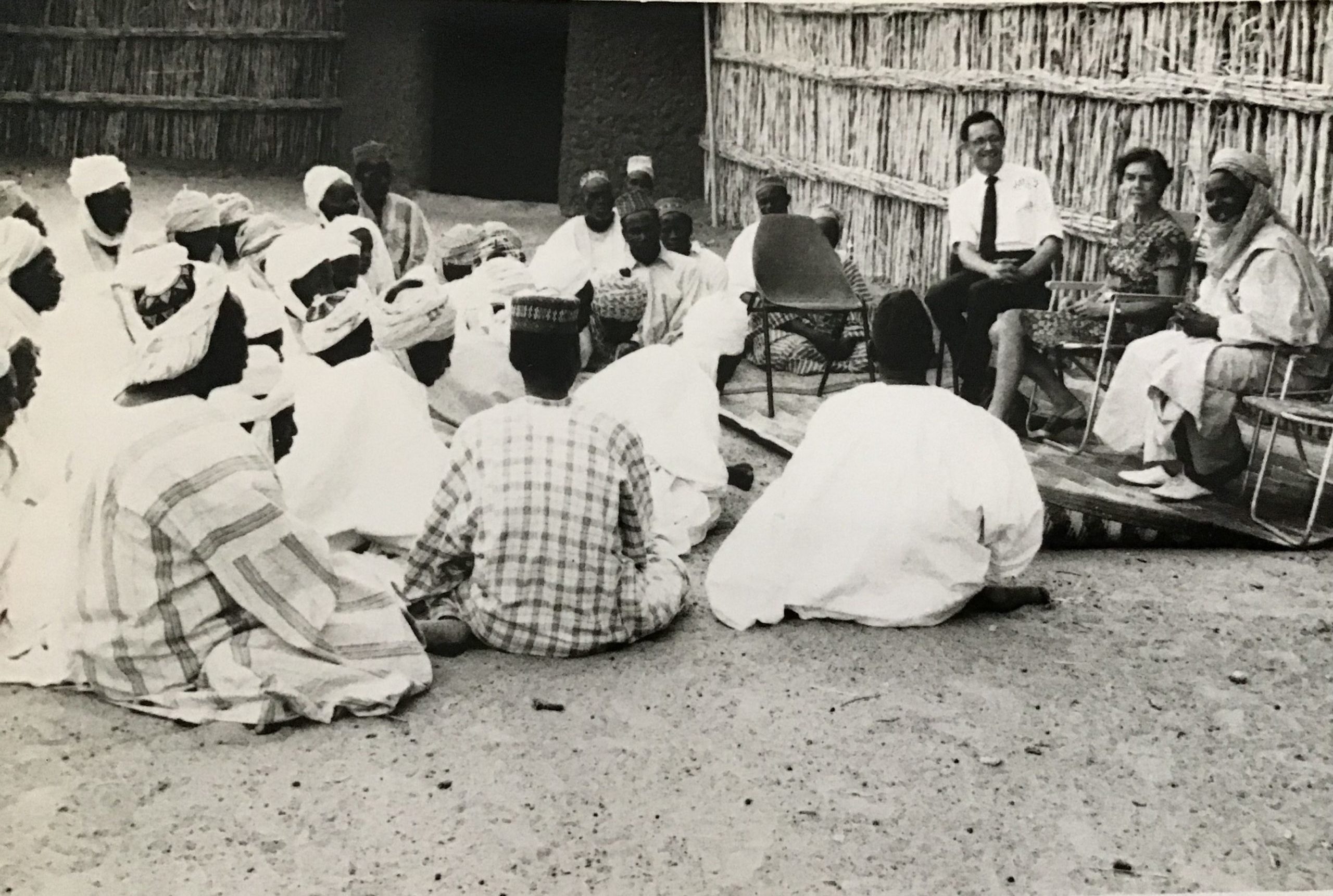 Judith and Gerald in Northern Nigeria with Alhaji Chigari, local chief of Gabasawa and his councillors. Here, they can be seen having a discussion about the work of MRA, translated by the Chief. They met while taking the film Freedom to the seven Emirs in their respective States. 