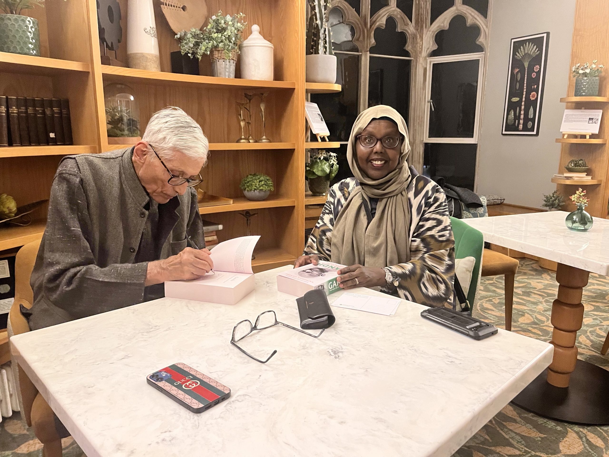 Dr Muna Ismail, Programme Manger for Refugees as Re-Builders getting a book signed by Rajmohan Gandhi. 
